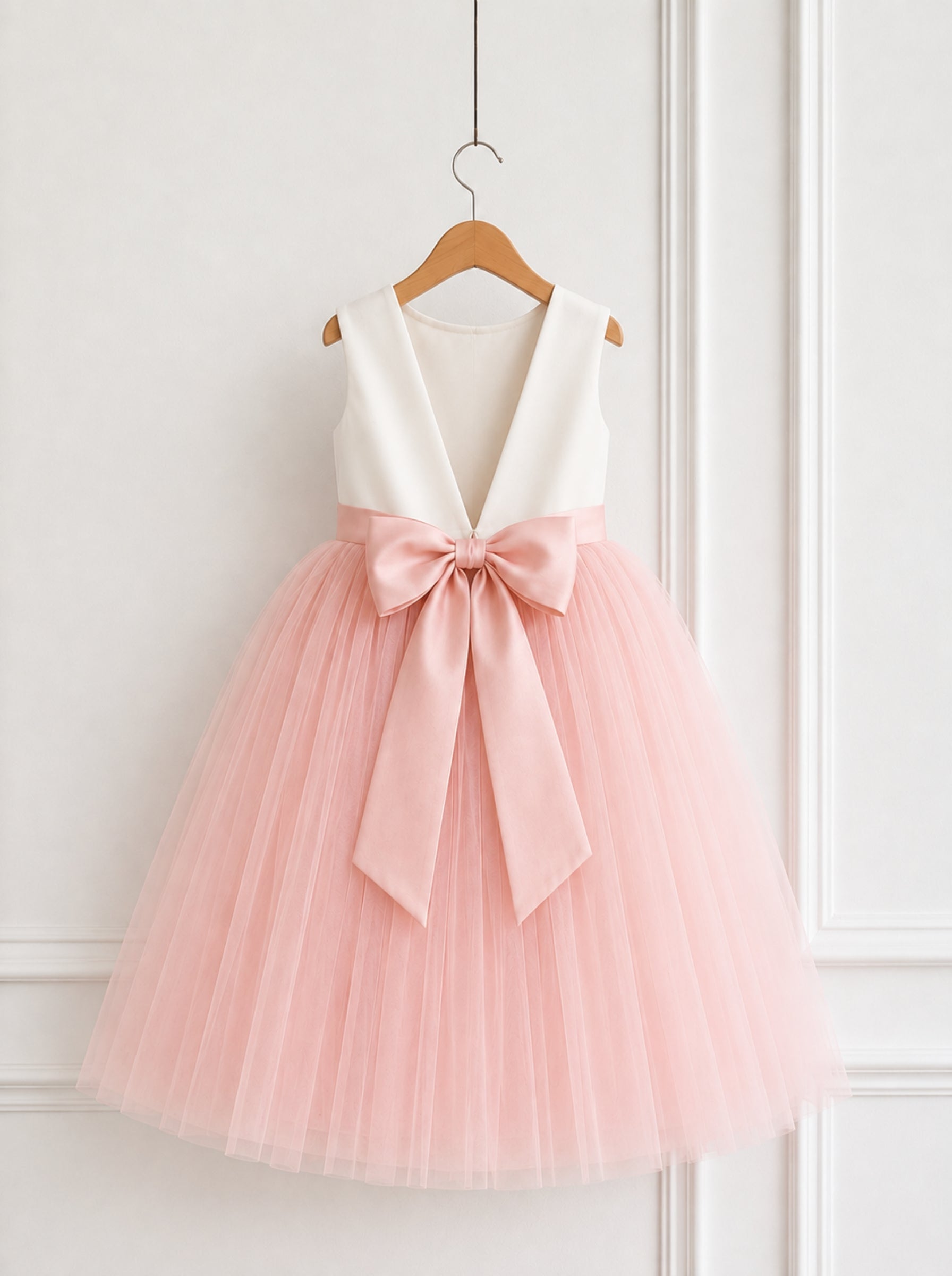 Blush pink flower girl wedding dress with deep V back and satin bow back view