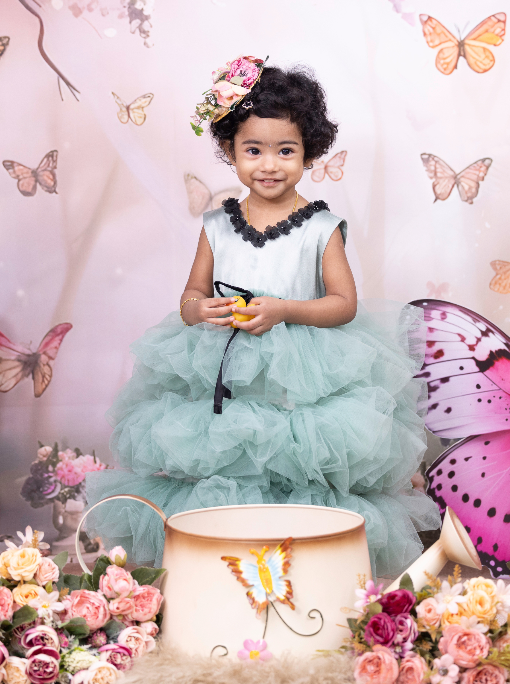 Little girl wearing a eucalyptus green tiered tulle dress