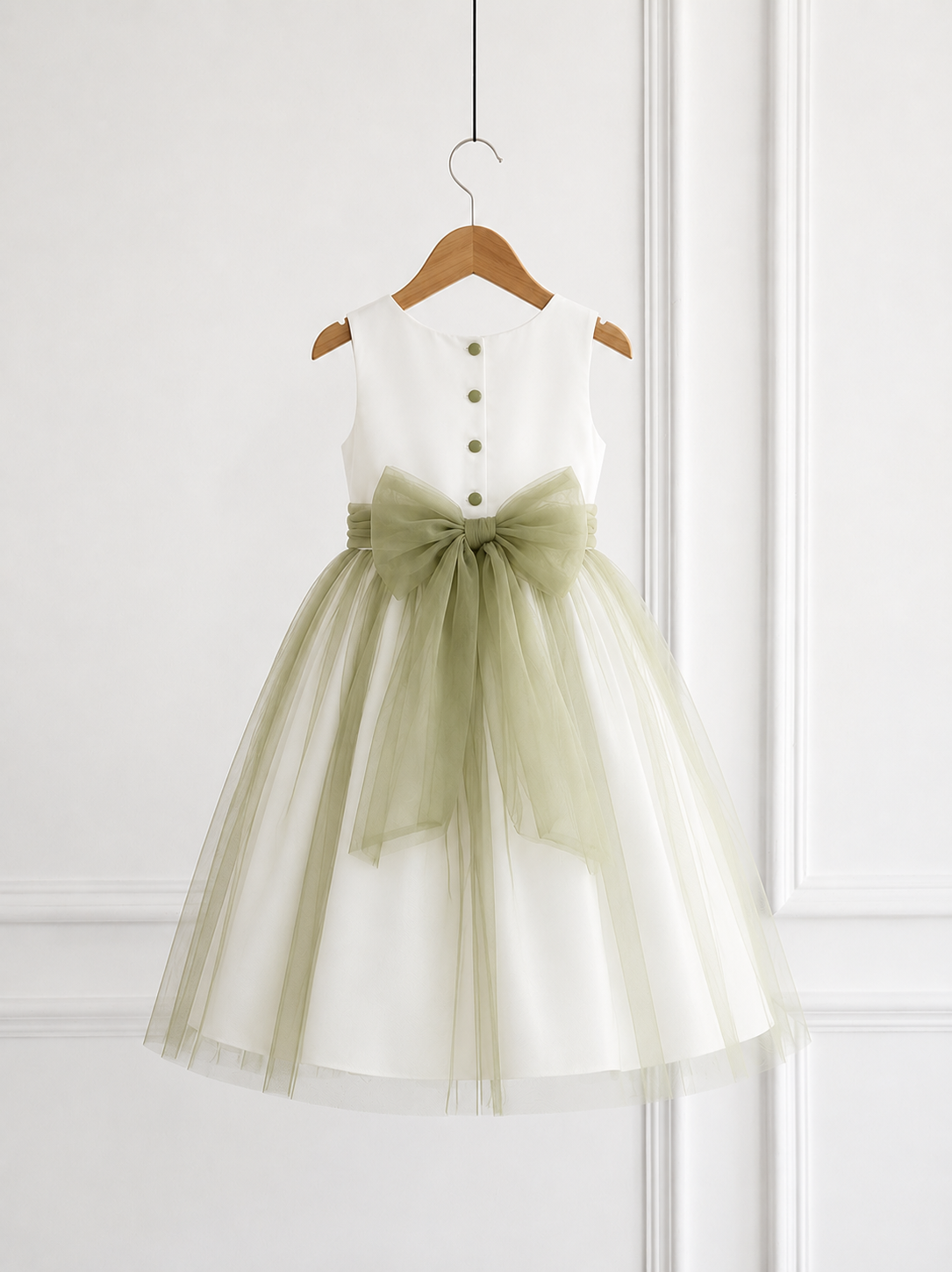 Back view of ivory and sage green flower girl dress with buttons and large tulle bow