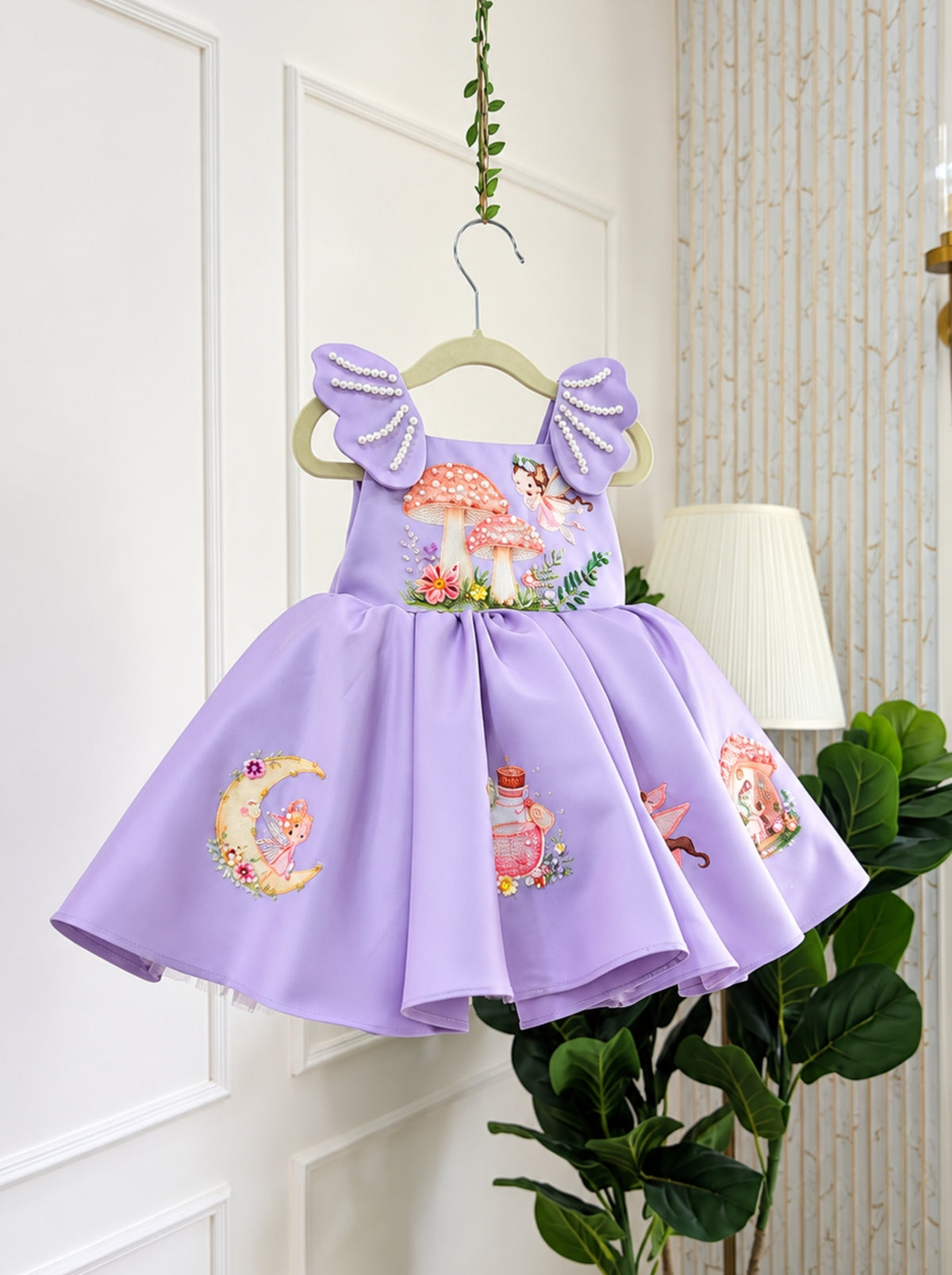 Lavender fairy birthday dress for girls in Duchess Satin with pearl embellished shoulder panels and magical mushroom artwork.
