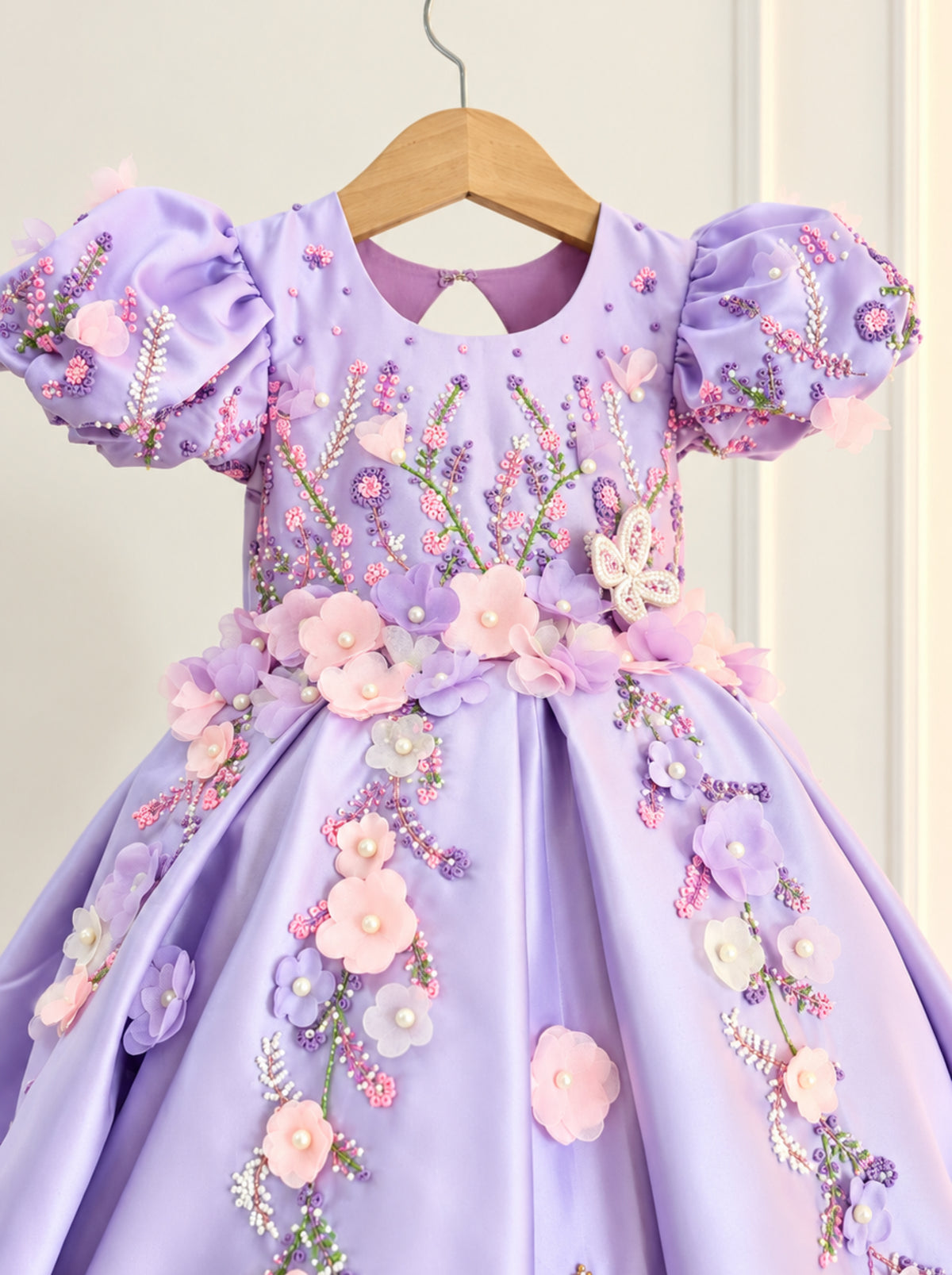 Close-up of lavender girls dress bodice with floral beadwork, pearls and 3D flowers