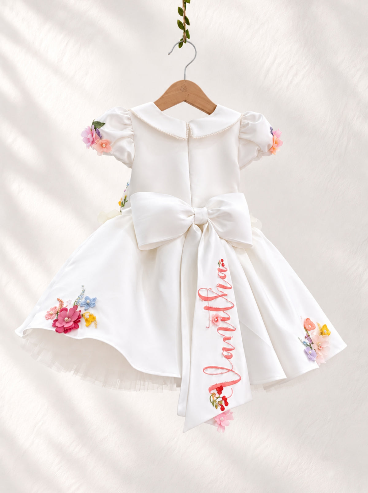 Back view of white floral birthday dress for girls with puff sleeves