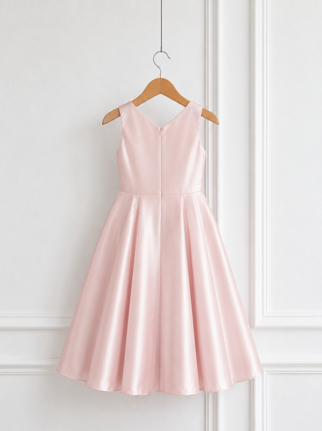 Back view of blush pink satin party dress for girls with sleeveless bodice, fitted waist and full A-line skirt.