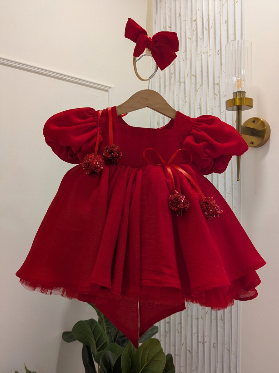 Close-up of oversized ruby red statement bow on girls couture party dress – Lauren Ann