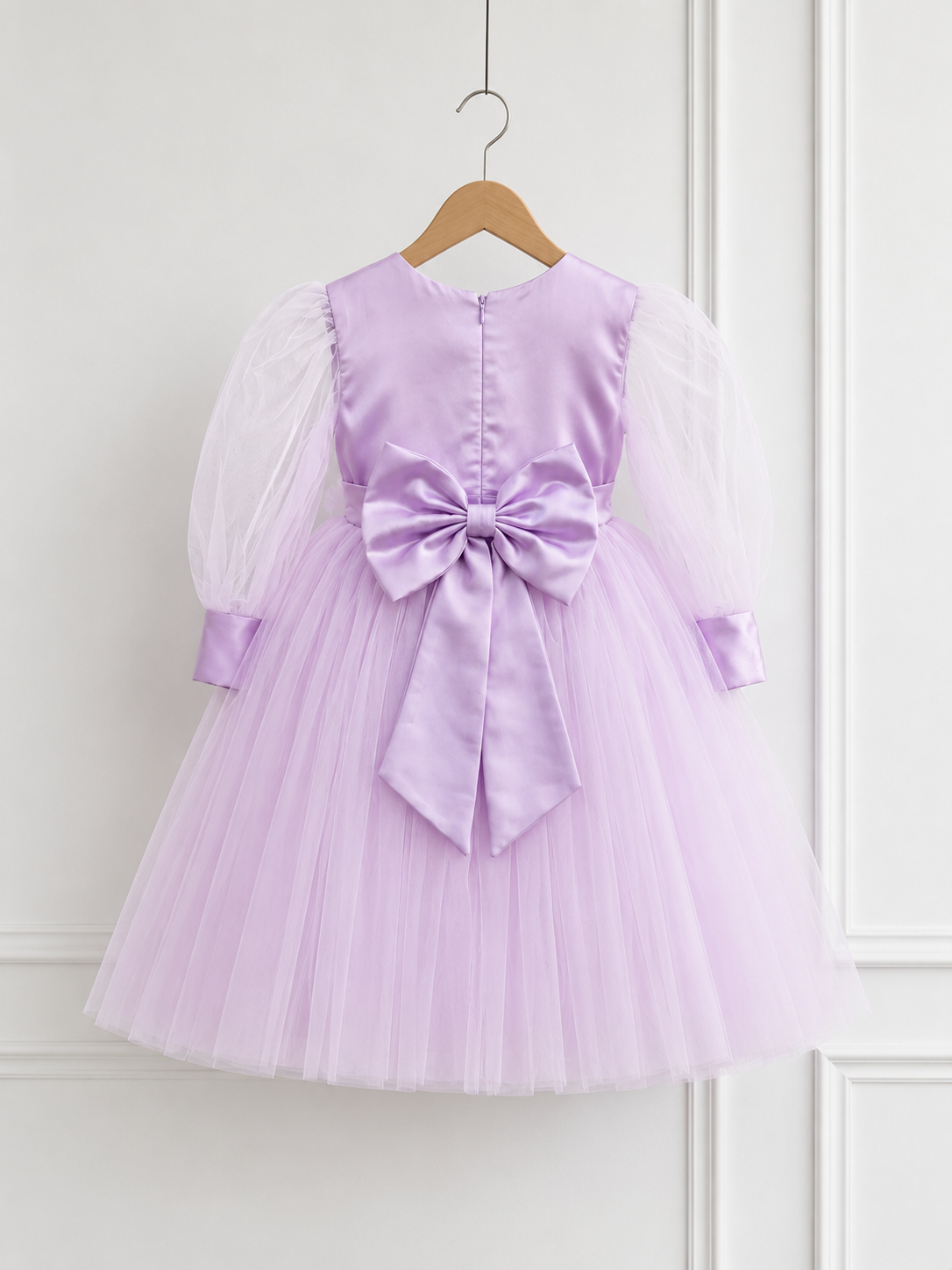 Back view of lavender princess dress for girls with oversized satin bow, puff sleeves and layered tulle skirt