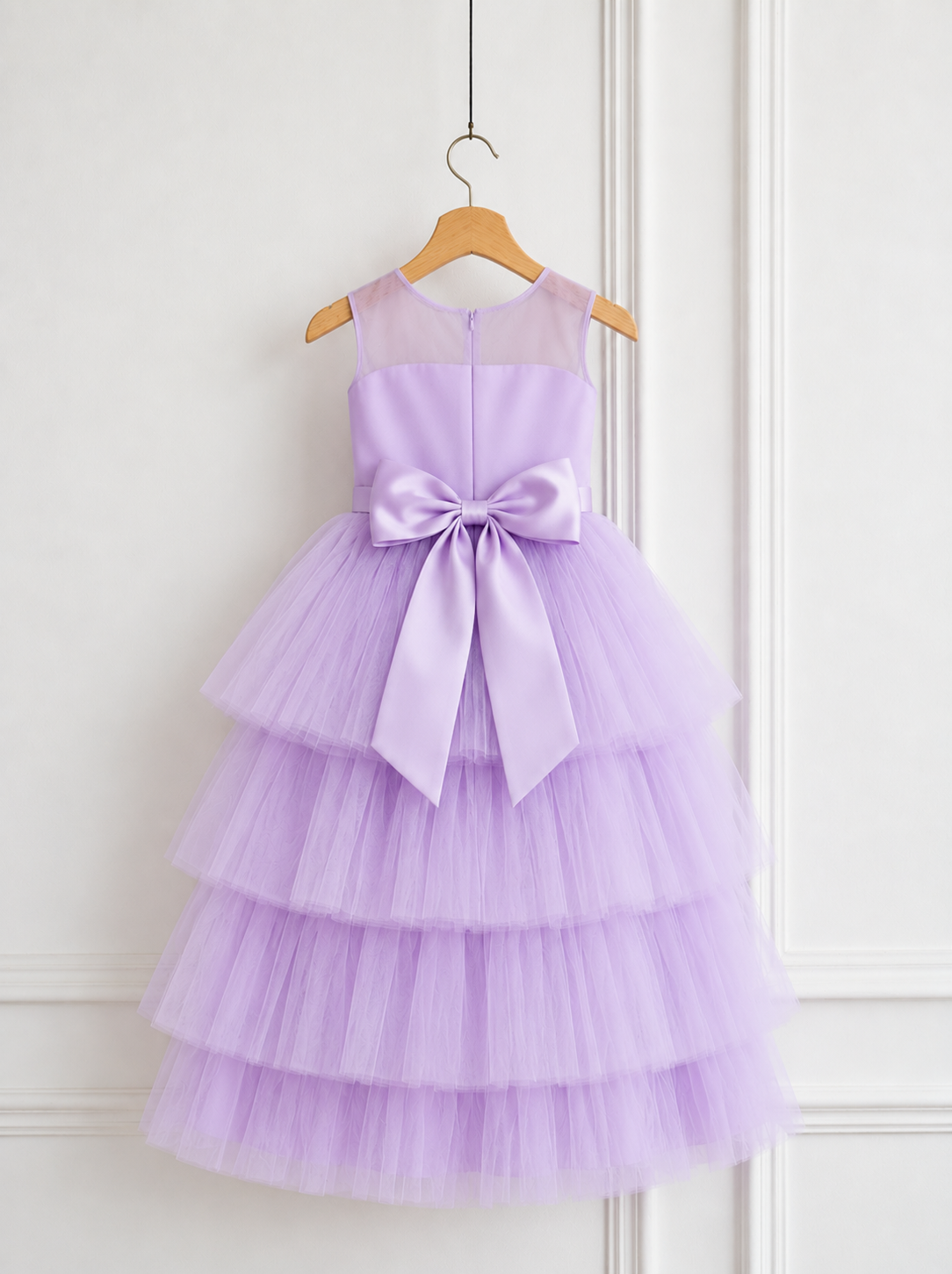 Back view of pastel lavender tiered tulle dress for girls with large satin bow and sheer neckline by Lauren Ann.