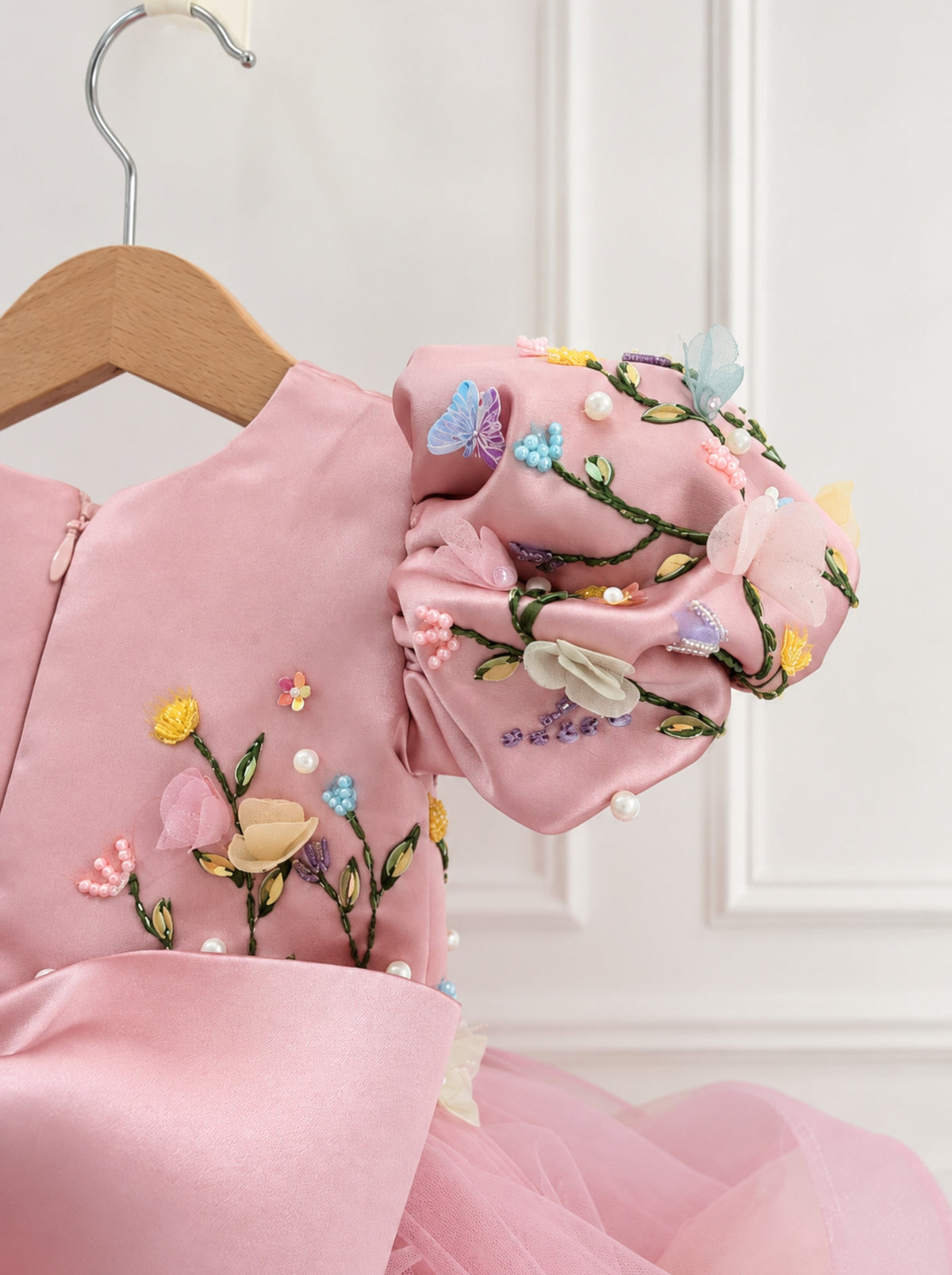 Pink satin sleeves with handmade floral embellishment on girls birthday dress