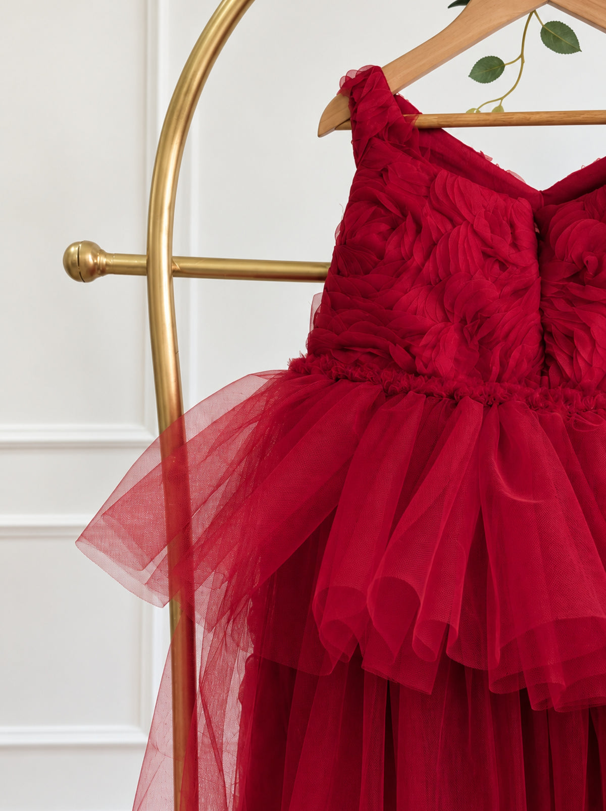 Close-up of premium 3D rosette fabric on red girls dress bodice