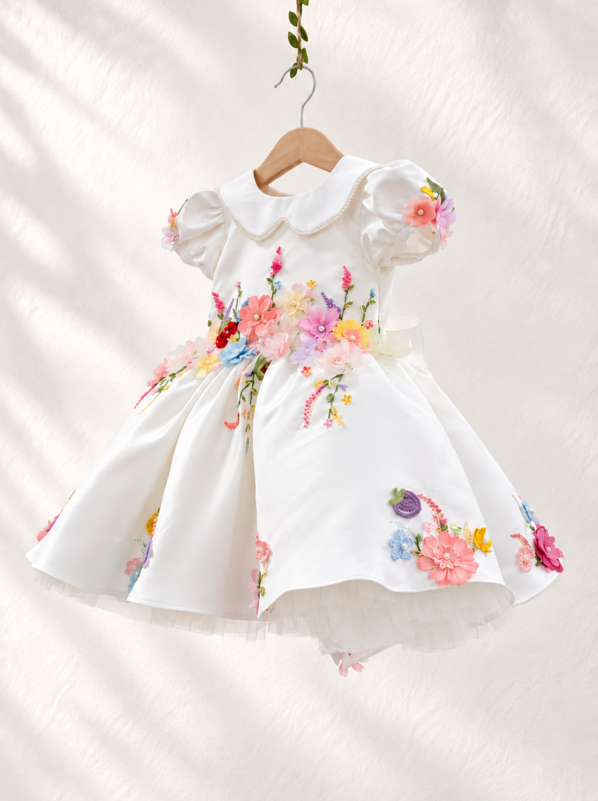 White flower girl dress with colourful 3D floral appliqué detailing