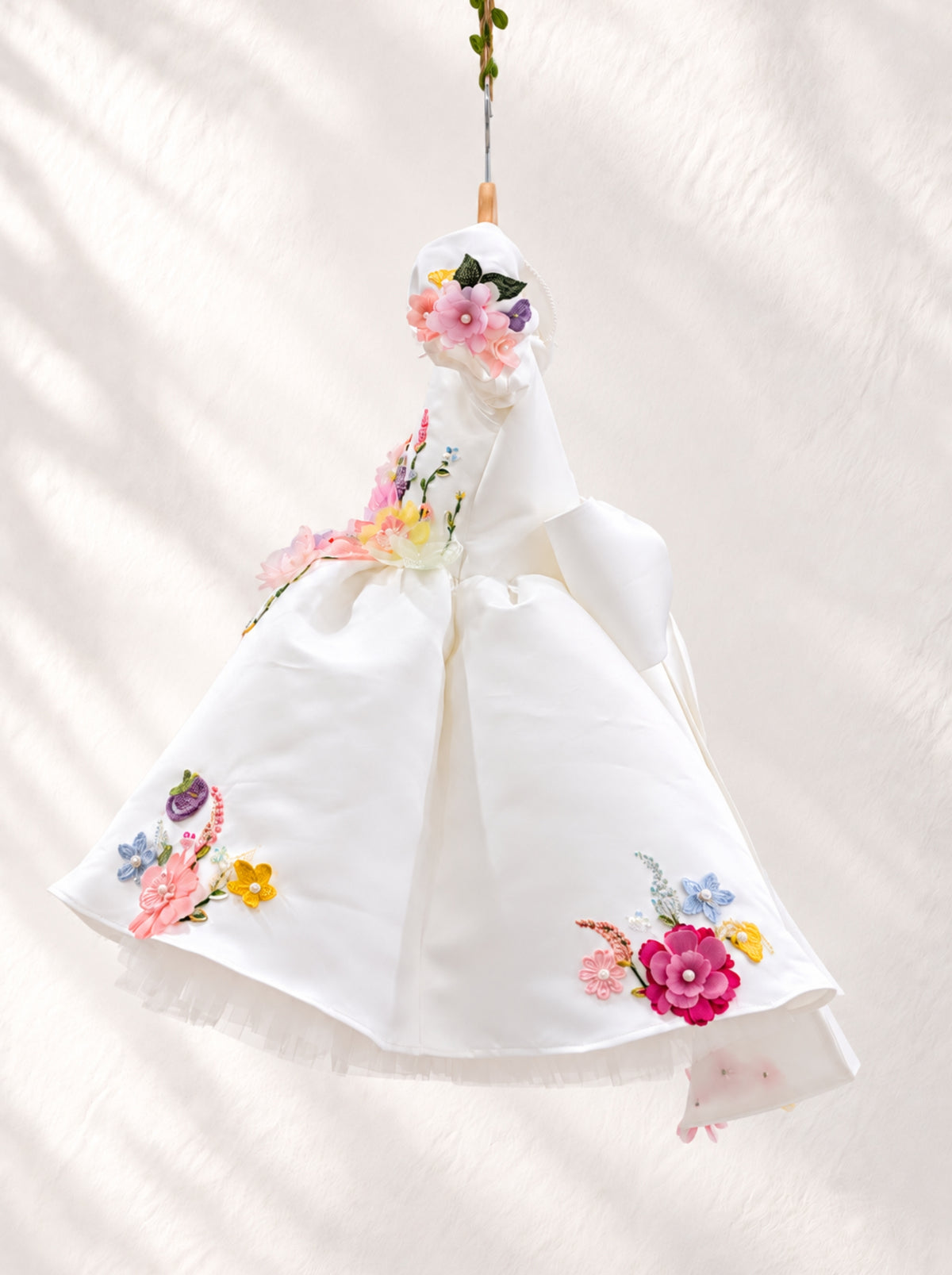 White flower girl dress with colourful 3D floral appliqué detailing