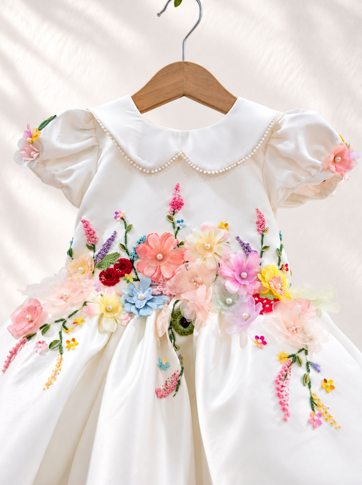 Front view of white floral birthday dress for girls with puff sleeves